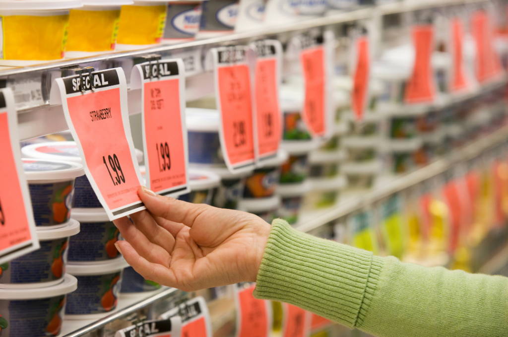 Close-up of price tags in a store aisle symbolizing pricing strategies for listing a house for rent.