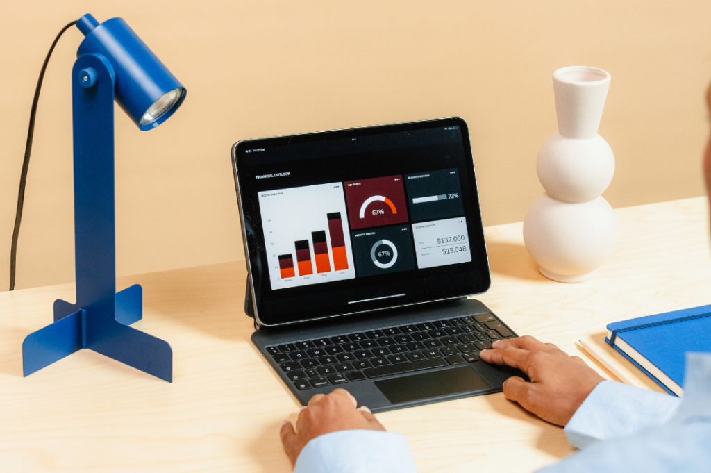 Person analyzing financial data on a tablet using any Airbnb management platform.