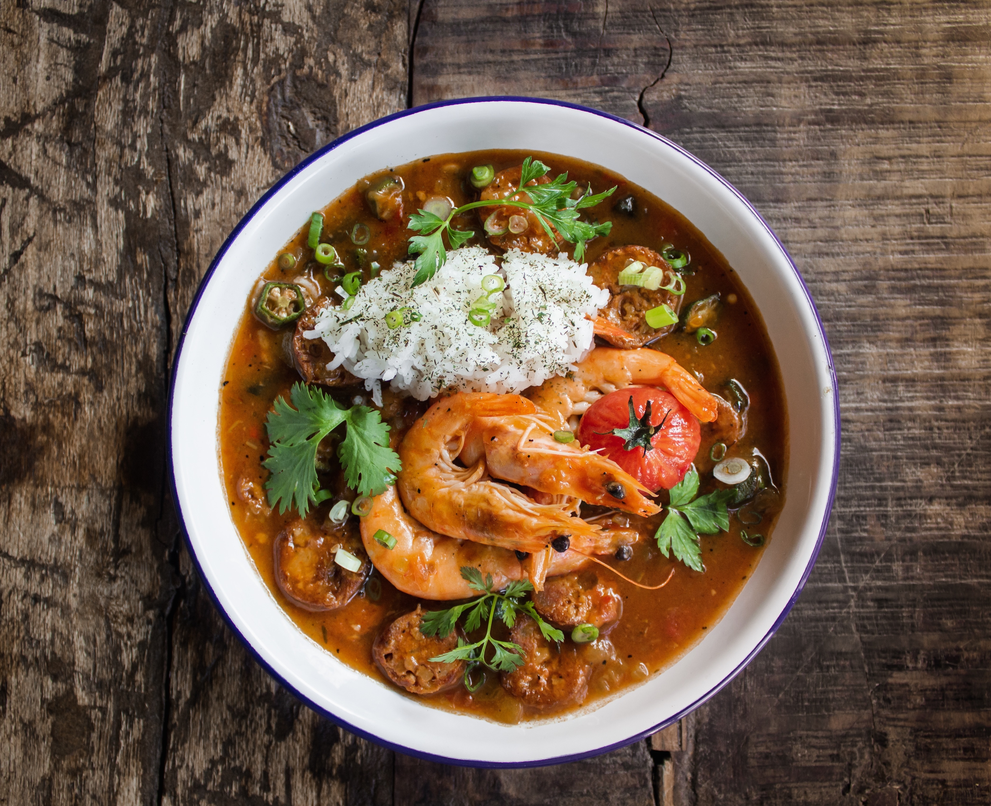 Gumbo served in a bowl with shrimp, sausage, and rice, showcasing the rich culinary traditions of travel destinations like New Orleans, Louisiana.