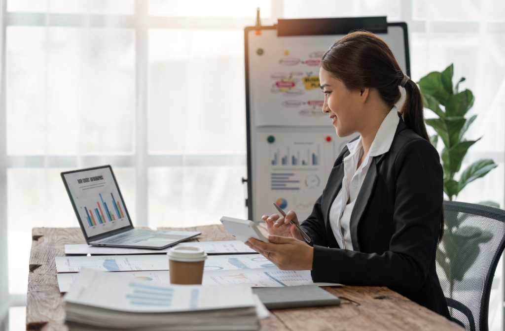 Businesswoman analyzing charts on her laptop—finding insights on whether there is any all-in-one website for rental property.